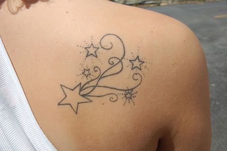 hip bone star tattoo.